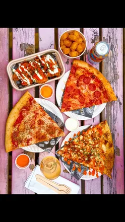 Food lovers enjoying Oxtail Birria pizza and fried chicken at Deadbeat x Bonehead pop-up in King's Heath.