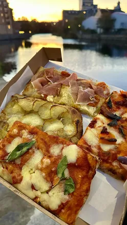 Delicious Roman-style pizza by the slice at Pala in Edinburgh, showcasing crispy bases and fresh toppings.