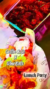 Guests enjoying a lively launch party at Cattle & Co in Swansea, featuring wings, nachos, cocktails, and bingo fun.
