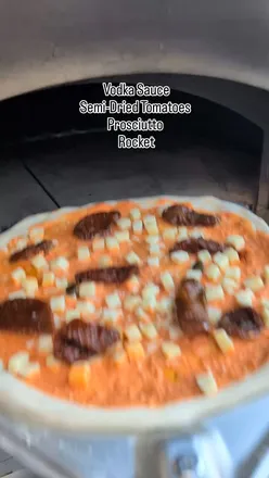 Delicious pizza and vodka sauce ready for a cozy Friday night at a local pizzeria.