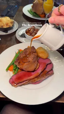 Ultimate Sunday roast at The Broughton in Edinburgh: tasty beef, Yorkshire pudding, and mimosas for a cozy afternoon.