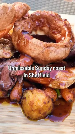 Sharing roast platter at Brocco Sheffield, featuring chicken, beef, Yorkshire pudding, and seasonal sides. Delicious!