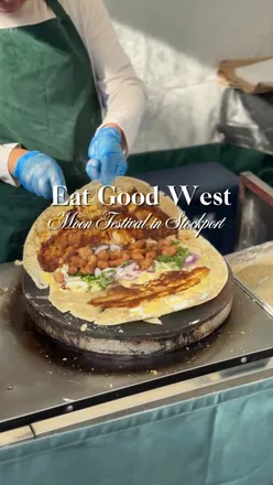Visitors enjoying vibrant Asian street food and festivities at the Eat Good West Moon Festival in Stockport.