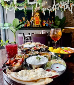 Spooky-themed promotion for a Bottomless Brunch giveaway at Indian Tiffin Room in Liverpool or Leeds, featuring cocktails and Indian dishes.