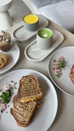 Interior of Axis Coffee in Willesden Green, showcasing sleek design and delicious coffee, pastries, and sandwiches.