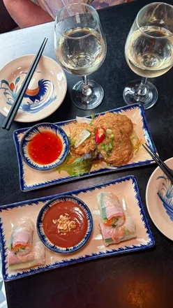 Dining under Vietnamese silk lanterns at Vietnam House, Edinburgh, enjoying authentic dishes and BYOB convenience.