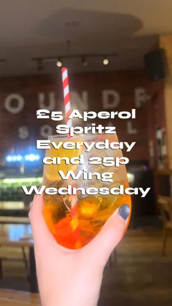 Enjoying £5 appy spritz and 25p wings at Foundry Social in Cardiff, vibrant atmosphere with live music and delicious food.
