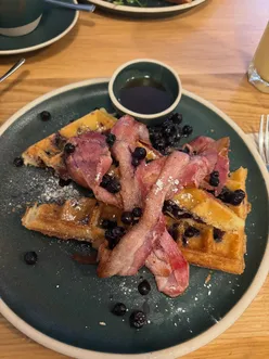 Delicious gluten-free waffles with blueberry compote and bacon at The Waffle House in Harpenden, Hertfordshire.