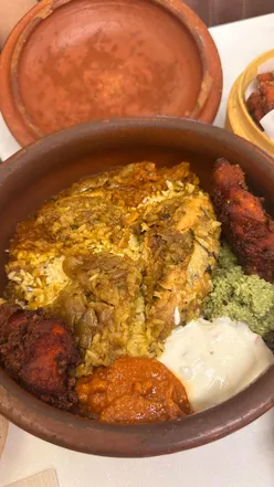 Spicy Chilli Mushroom Dry and traditional Chatty Biryani at Ikkayees, a top Indian restaurant in Liverpool.