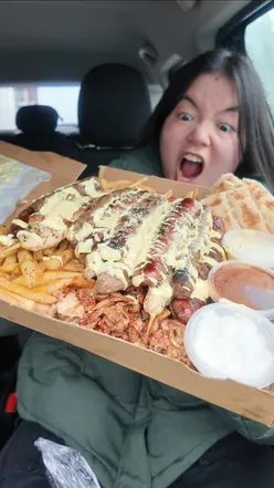 Delicious Greek street food being served at Gyro Hero in Bearsden, Glasgow, featuring gyro wraps and fresh ingredients.