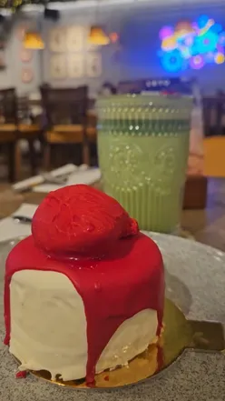 Spooky Halloween treats at L'ETO Caffe, featuring a matcha latte and artistic macaron in London.