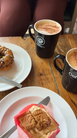 Friends enjoying Pumpkin Spice Lattes and sweet treats at Coffee#1 in Pontcanna during a cozy autumn morning.
