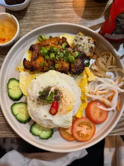 Delicious Broken Rice with Pork and Stir Fry Noodles at Tonkin Newcastle, featuring vibrant flavors and a cozy ambiance.