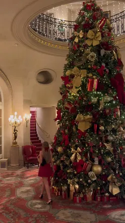 Guests enjoying festive decor and holiday cheer at The Ritz London during Christmas season.