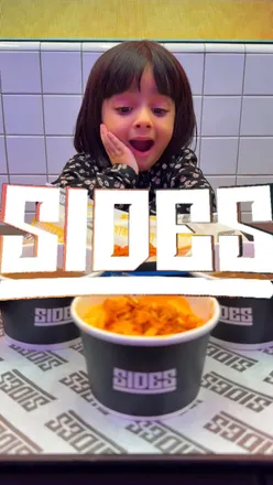 Family enjoying festive burgers at Sides, the best burger spot with 11 chicken flavors and holiday vibes.