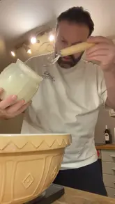 A home cooking video documenting the process of making sourdough bread from scratch, including starter preparation, dough handling, and baking on a Kamado Joe grill.