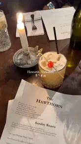 A montage of clips showcasing the village of Haworth, Yorkshire, including scenic views of the moors, local shops, and food from a local establishment.