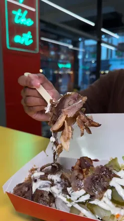 Robots preparing 100% chicken and beef doner wraps at Great British Doner, Manchester, featuring a unique chocolate crepe dessert.