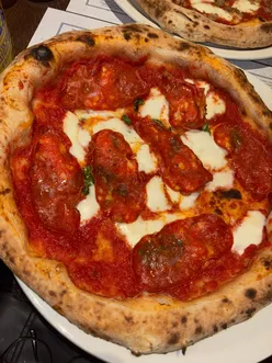 Delicious Tuscan fennel sausage and Calabrese salami pizzas at Paesano Pizza in Edinburgh during a festive trip.