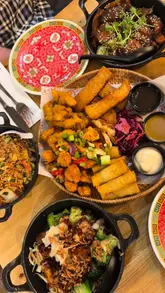 Delicious dishes at Mans Market in Leeds, showcasing the January special: 50% off all mains, grains, and noodles!