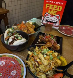 Delicious dishes at Man’s Market in Leeds, featuring tofu, noodles, and duck bao buns—perfect for a January sale!