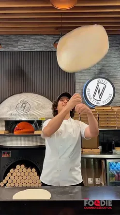 Family enjoying Neapolitan pizza at Naples Liverpool, featuring classic Margherita and seafood options in Aigburth.