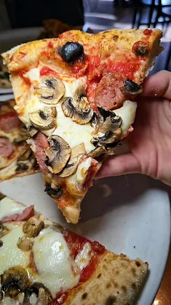 Delicious Neapolitan pizzas at Mozza St Andrews, featuring ham & mushroom and goats cheese with caramelised onion.