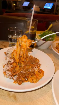 Delicious Italian tapas at Osteria Mbare, featuring arancini, zucchini fries, bruschetta, and various pasta dishes.