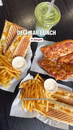 Enjoying box meals with paninis and fries at Panini City, a cozy deli in Glasgow's East End.