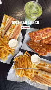 Enjoying box meals with paninis and fries at Panini City, a cozy deli in Glasgow's East End.