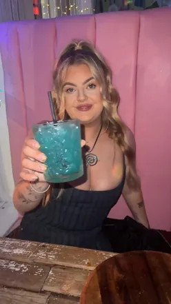 Friends enjoying cocktails and free mini pizzas at Cuckoo in Leeds, the perfect pre-drinks spot for fun and laughter.