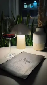 A slow-paced, atmospheric video showcasing the interior and vibe of Mayvn, a venue that transitions from a cafe during the day to a wine bar at night. The footage focuses on decor, lighting, and drinks.