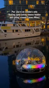 A montage of clips featuring a floating igloo boat experience in Canary Wharf, London. The video captures the nighttime skyline, the interior of the heated igloo, and the cheese fondue dining experience.