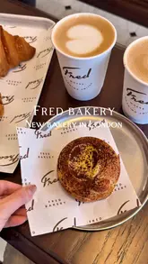A short, aesthetic montage showcasing the interior and pastry selection of Fred Bakery in London, featuring close-ups of croissants, sandwiches, and coffee.