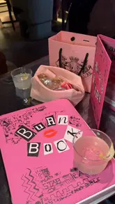 A fast-paced, aesthetic promotional video for a Mean Girls-themed cocktail experience at Somewhere by Nico. The video features thematic props like a 'Burn Book', pink decor, and close-ups of cocktail preparation and service, set to upbeat music.