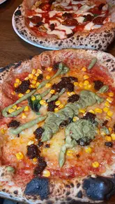 A fast-paced montage showcasing a visit to Crust Bros, featuring cocktails, various pizza options, and sides like pasta crisps and fries. The video captures the buzzing atmosphere of the restaurant and highlights the menu offerings.