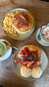 A promotional reel for The Cabin in Sheffield, highlighting their pancake offerings for Pancake Day. The video features close-ups of 'The Works' and 'Strawberry & Nutella Heaven' pancakes, along with branded coffee art and the cozy, cabin-themed interior.