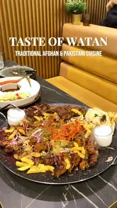 A promotional video for Taste of Watan, showcasing their large family platter featuring a variety of Afghan and Pakistani grilled meats, rice, and sides, alongside refreshing mocktails in a modern restaurant setting.