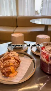 A short, aesthetic video showcasing the interior and food offerings of Kloud, a cafe in Glasgow's Merchant City. The video features shots of the counter, pastries, coffee, and an acai bowl, set to music with text overlays.