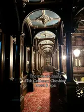 A visually striking, symmetrical shot of a grand, historic corridor within a 17th-century hotel, highlighting the intricate wood panelling and ornate ceiling details. The lighting is warm and atmospheric, perfectly suited to the venue's heritage aesthetic.