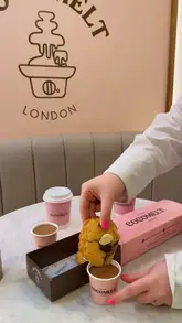 A short, visually focused promotional video for Cocomelt London, highlighting their signature chocolate fountain and cookie-dipping experience. The video uses close-up shots to emphasize the texture and indulgence of the desserts.