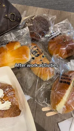 Group of friends enjoying drinks and appetizers after work at a lively bar atmosphere.