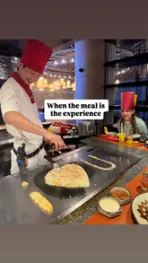 A short, energetic video capturing the interactive teppanyaki cooking experience at Benihana. The footage focuses on the chef's knife skills, fire tricks, and egg juggling, while also showing children enjoying the performance. The video effectively communicates the fun, family-friendly atmosphere of the venue.
