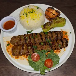 “Delicious Turkish dishes including hummus, tzatziki, and Adana kebab at Luminous restaurant in Liverpool.”