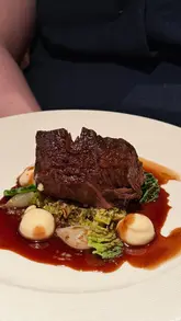 A montage showcasing a high-end dining experience aboard the Fingal ship in Leith, featuring cocktails, various courses, and the restaurant's interior.