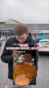 A food review video featuring a creator visiting Browns Fish & Chips in Belfast to try their Louisiana Tender Tray. The video includes a walk-up to the venue, a close-up of the food, and the creator's taste test and rating.