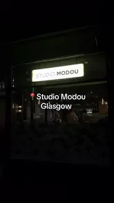 A personal review of Studio Modou in Glasgow, showcasing a three-course set menu priced at £25 per person. The video features the restaurant's interior, cocktails, and various dishes including a scotch egg, mushroom velouté, duck, and chocolate fondant.