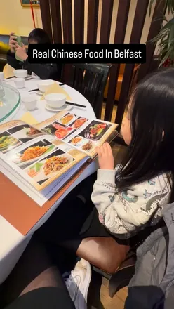 Authentic Chinese cuisine served in a vibrant Belfast restaurant, showcasing traditional dishes and a lively atmosphere.