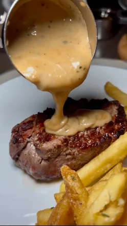 Couple enjoying a romantic date night with Argentinian steaks at Gaucho in Cardiff, surrounded by elegant decor.