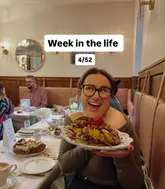 A creator poses with a plate of pancakes at a Lindt cafe, documenting a 'week in the life' style brunch visit.